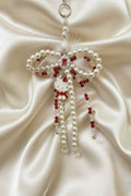 Handmade Hello Kitty beaded keychain with pearls, red crystals, and feather bow on satin