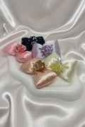 Handmade beaded satin bows in pink, navy, lavender, peach, and cream for DIY accessories and crafts