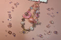 Handmade beaded charm with pink moon, angel wings, and pastel beads for DIY accessories
