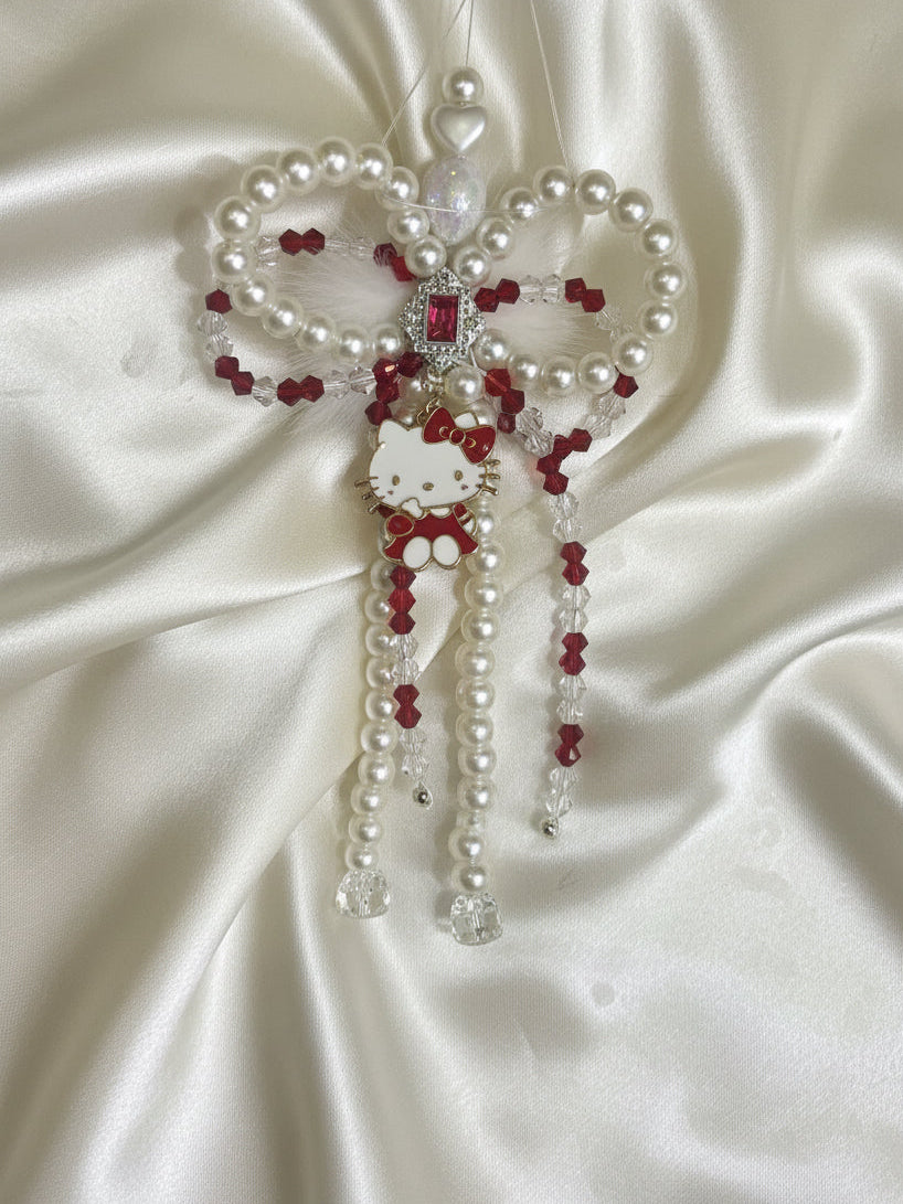 Hello Kitty beaded charm with pearls, red crystals, and bow on satin — handmade DIY accessory