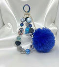 Handmade beaded keychain with blue pom-pom, shark charm, and colorful beads for DIY accessories