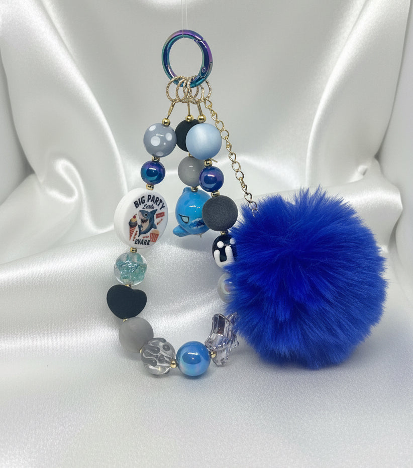 Handmade beaded keychain with blue pom-pom, shark charm, and colorful beads for DIY accessories
