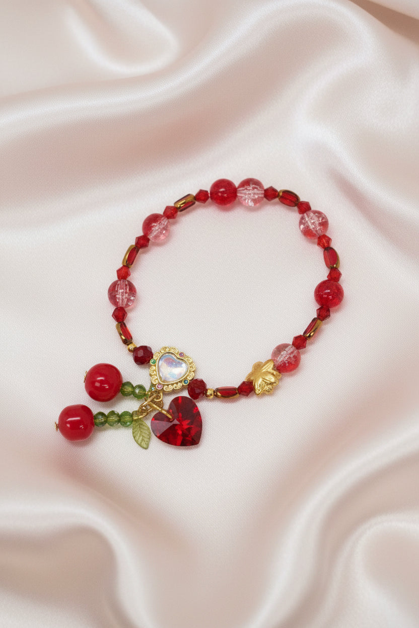 Handmade cherry-themed beaded bracelet with red heart charms, perfect for DIY accessories and craft supplies.