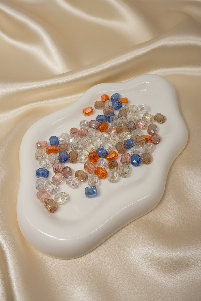 Colorful faceted beads for DIY jewelry making on satin fabric