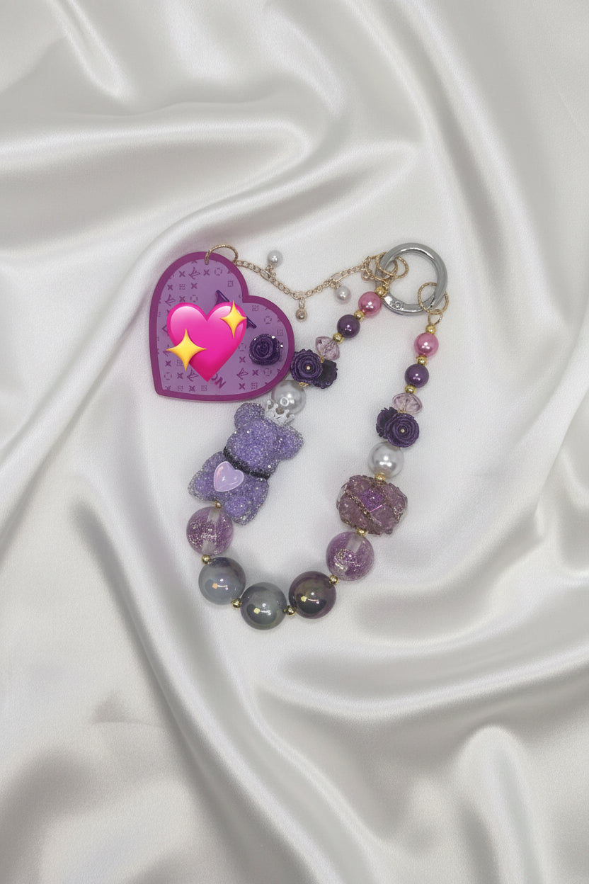 Purple beaded keychain with glitter bear, heart charm, and floral beads on satin
