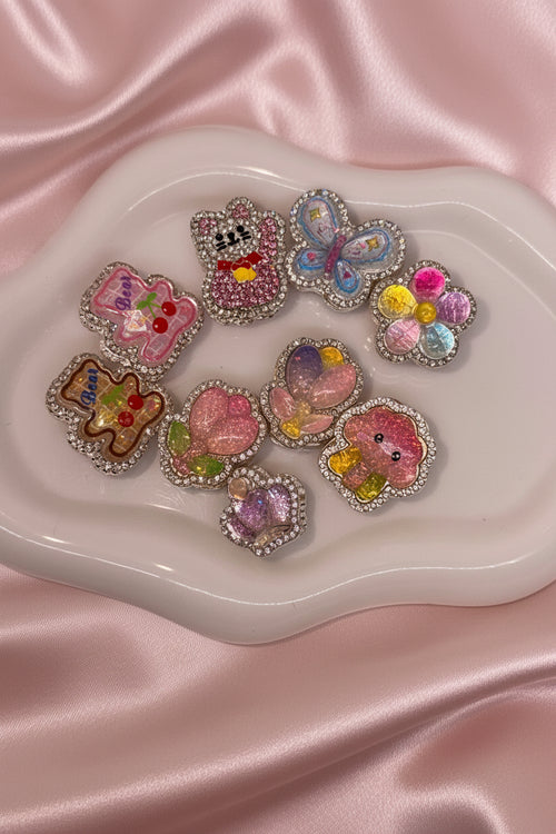 Cute beaded charms with glitter, rhinestones, and pastel designs for DIY accessories and crafts