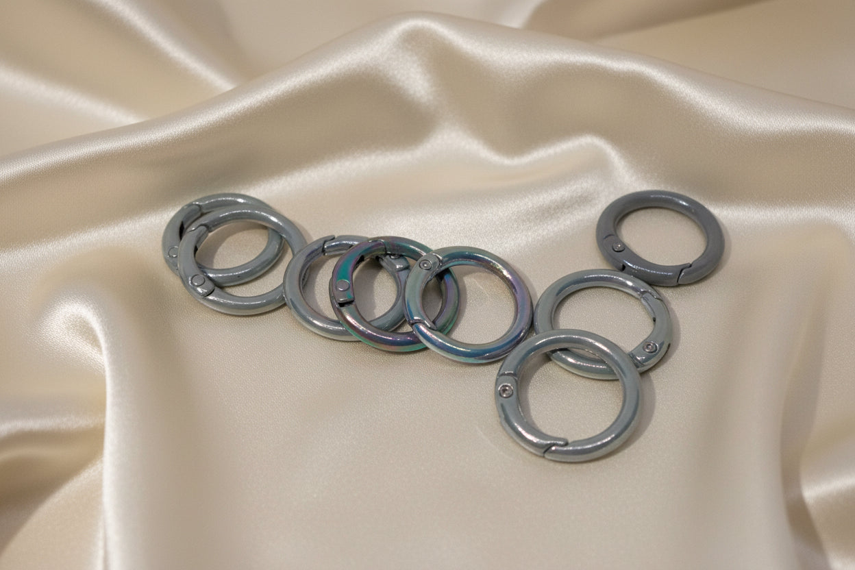 Metal jump rings for DIY jewelry making on satin fabric