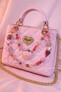 Pink quilted handbag with beaded charm strap, heart locket, and 'Love Potion' pendant, perfect for DIY accessory lovers