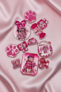 Pink glittery Betty Boop charms, paw prints, and accessories on satin fabric for DIY crafts