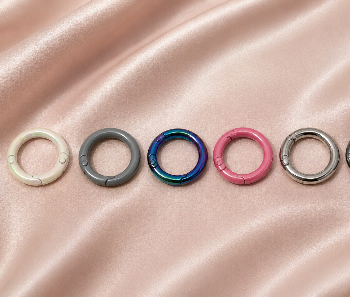 Colorful snap rings for DIY jewelry making on satin fabric