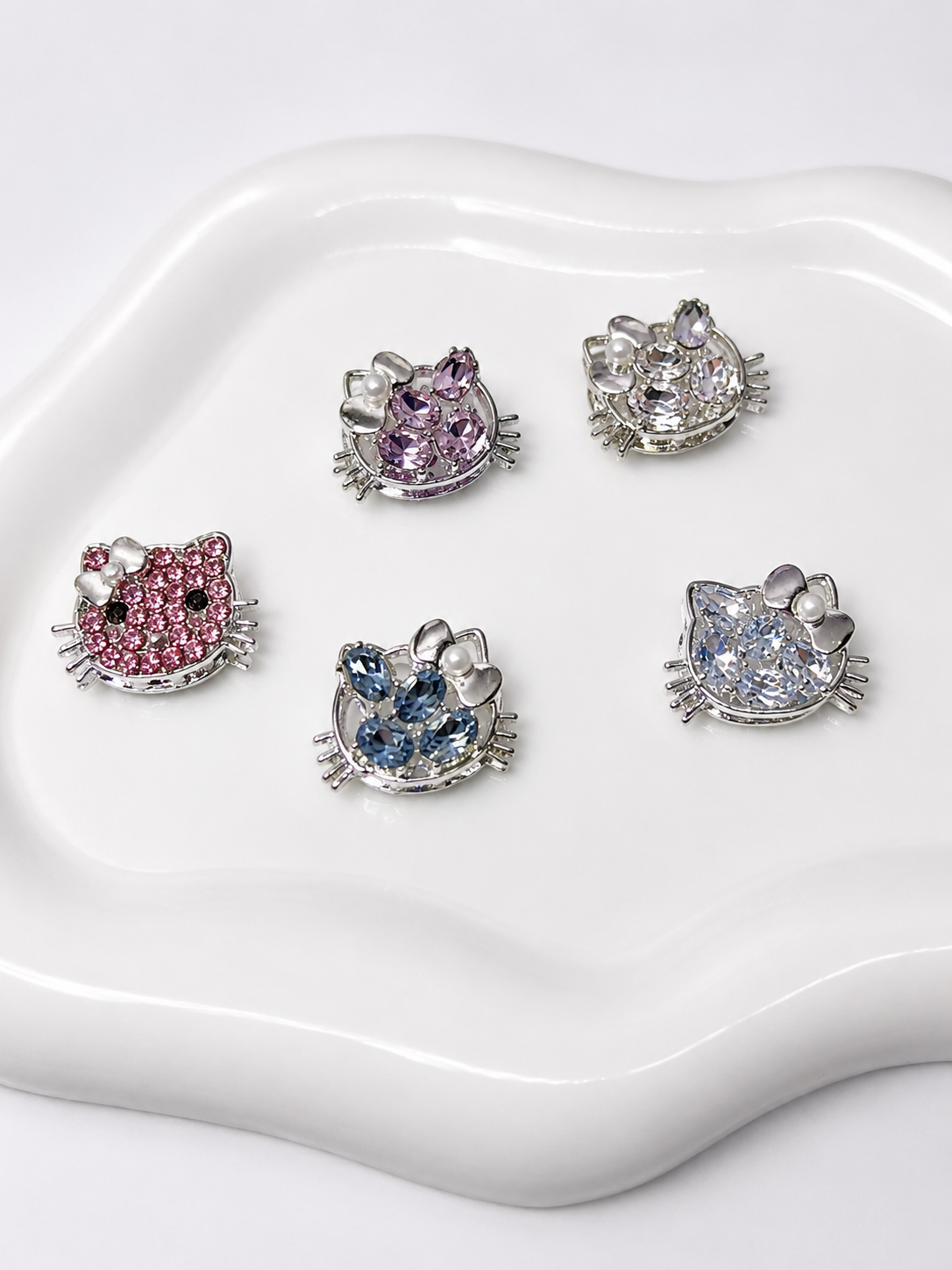 Hello Kitty rhinestone charms in pink, purple, blue, and clear for DIY jewelry making