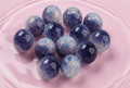 Handmade beaded spheres in blue and purple, perfect for DIY jewelry crafts and accessories