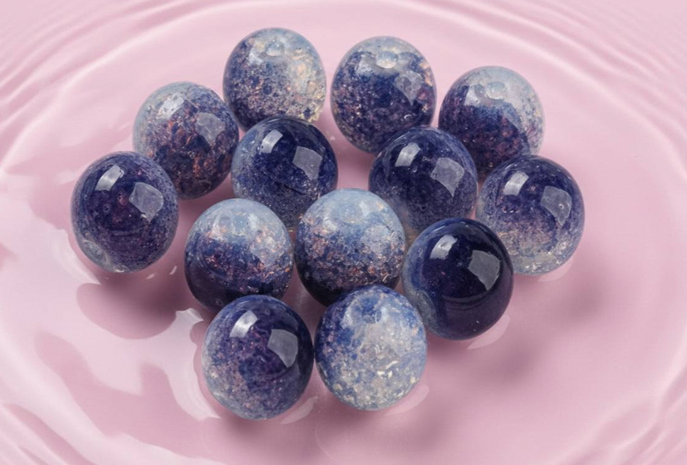 Handmade beaded spheres in blue and purple, perfect for DIY jewelry crafts and accessories